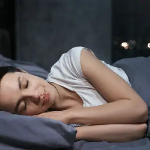 A woman sleeping comfortably without sleep apnea 